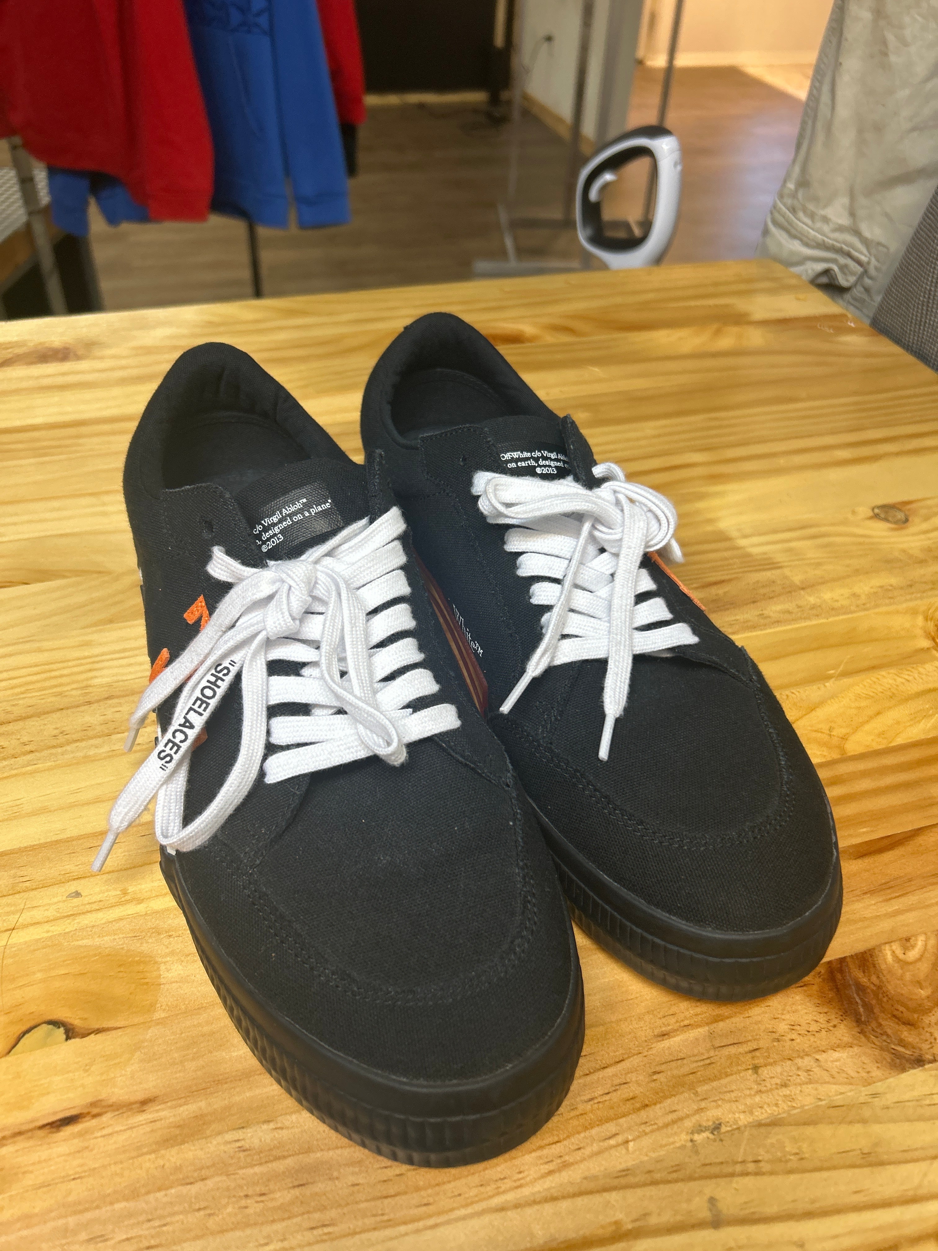 This is an Off-White Vulc Sneaker in the 'Black Orange' colorway