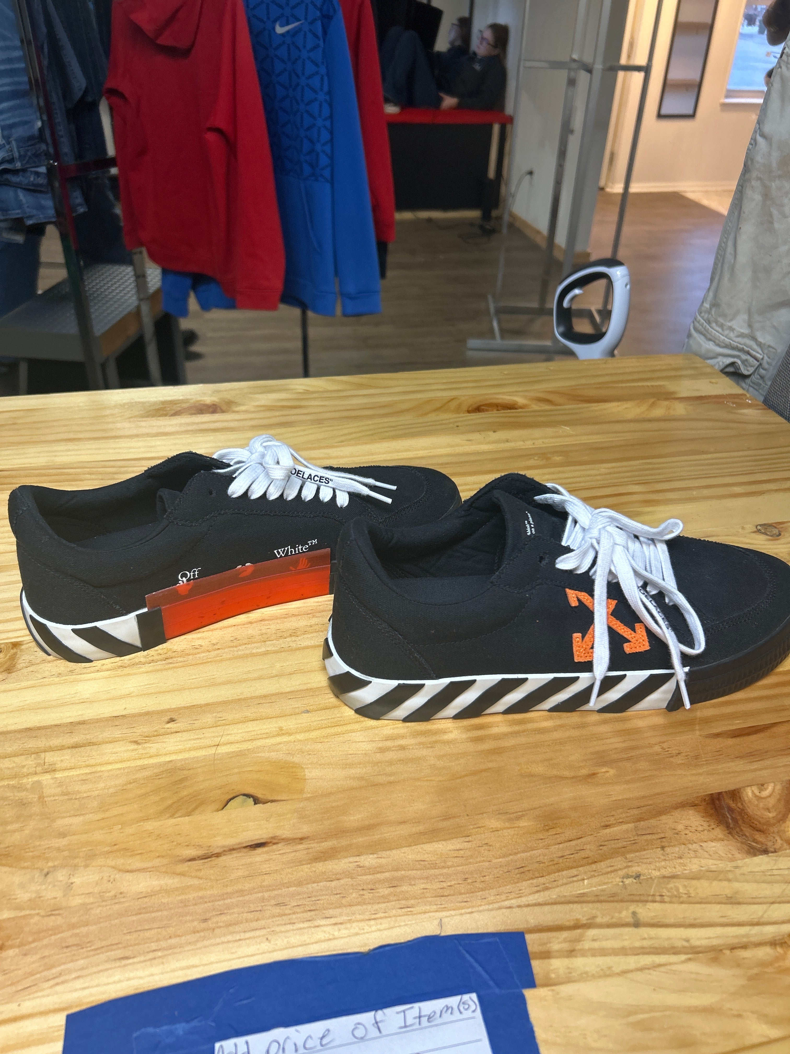 This is an Off-White Vulc Sneaker in the 'Black Orange' colorway